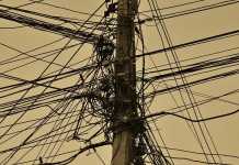 Competition for the wireless last mile Telephone pole with multiple cables.