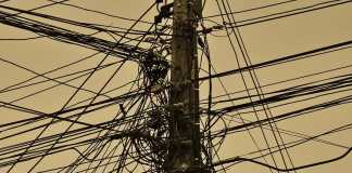 Competition for the wireless last mile Telephone pole with multiple cables.