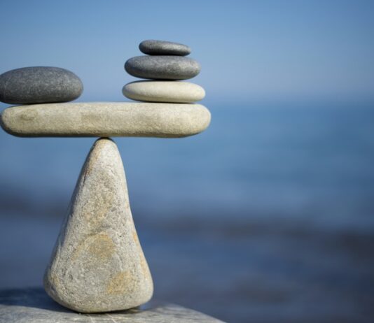 Can SMBs demonstrate climate action? pebbles piled in balance - environmental sustainability