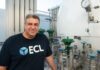 ECL unveils world’s first off-grid, hydrogen-powered AI data center ECL engineer beside hydrogen tanks
