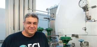 ECL unveils world’s first off-grid, hydrogen-powered AI data center ECL engineer beside hydrogen tanks